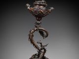 an image of a bronze statue of a dragon on a pedestal