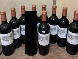 bottles of red wine are lined up in a row on a counter