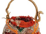an orange and gold purse with a snake handle on a white background