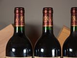 three bottles of wine are sitting in a wooden box