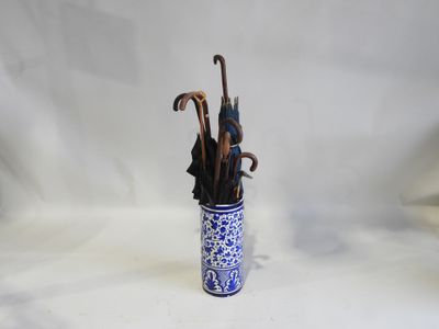 un vase bleu et blanc contenant des parapluies