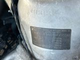 a close up of a motor bike with a number plate on it