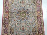 a blue and red rug with a medallion design on it