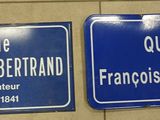 deux panneaux de signalisation bleus accrochés à un mur dans des toilettes publiques