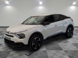 the white car is parked in a large room with checkered floor