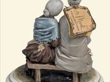 a figurine of two people sitting on a bench
