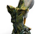a statue of a bird that is sitting on a rock