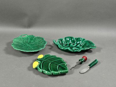 three pieces of green pottery sitting on top of a table