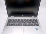 an open laptop computer sitting on top of a white table