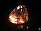 a close up of a diamond on a black surface