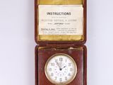 a small brown box with a clock inside of it
