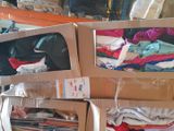 many boxes of clothes that are stacked on top of each other