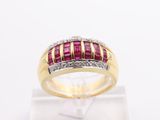 a close up of a yellow gold ring with a ruby and diamond band