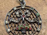 a close up of a pendant on a wooden surface