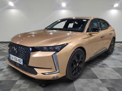 the front view of a beige 2021 infiniti suv parked on a checkered floor