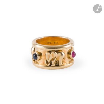 a close up of a gold ring with elephants and gems