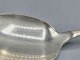 a silver spoon with a handle on a table