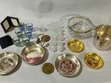 a lot of silver and glass items on the table