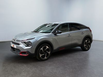 un SUV argenté garé dans une pièce aux murs blancs