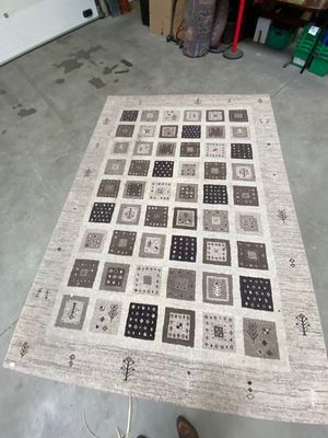 a person standing next to a rug on the floor