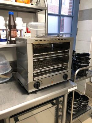 a toaster oven sitting on a counter in a kitchen