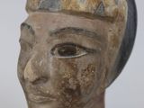 statue of a woman ' s head with a hat on top of a clear base