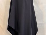 a white mannequin with a black cape on top of it