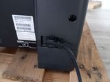a black printer sitting on top of a wooden pallet