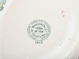 a white plate with a design on it on a table