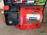 an image of a red and black pump sitting on top of a box