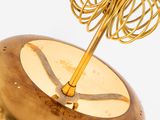 a gold clock that has a gold umbrella on top of it