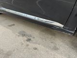 a black car parked on the side of the street