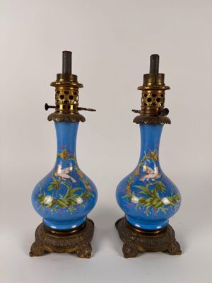 pair of blue vases with flowers and birds painted on them
