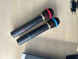 two microphones sitting on a table next to a laptop