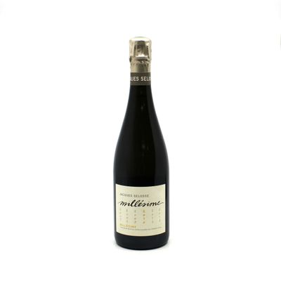 the bottle of wine is sitting on a white surface