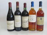 several bottles of wine are lined up on a white surface