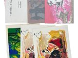 several cards with paintings on them sitting on top of each other