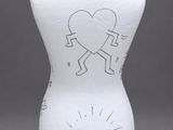 a white vase with a drawing of a man and a dog on it