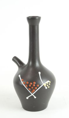 a black vase with a design on it