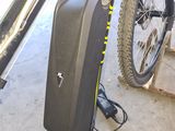 a bike with a suitcase attached to the back of it