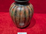 a vase that is sitting on a red surface