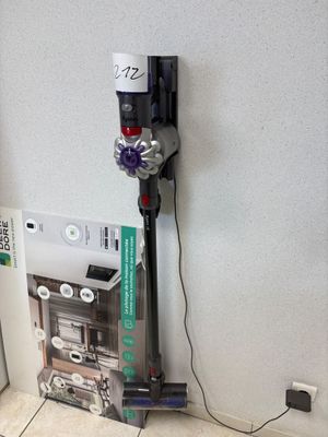 a vacuum that is sitting on the floor next to a wall