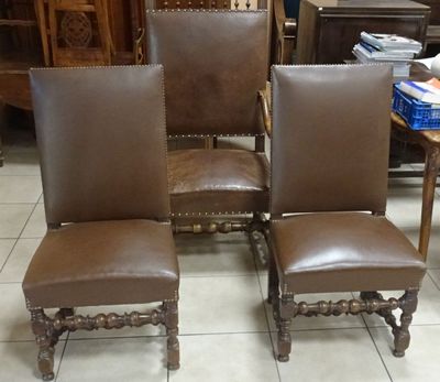 three brown leather chairs sitting on top of a tiled floor