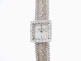 an image of a woman ' s wrist watch with a chain around it