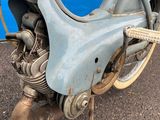a blue motorcycle parked on the side of the road