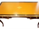 an image of a table with a gold top and black legs