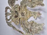 an image of a silver brooch with a bird on it