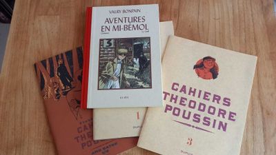 three books sitting on a table next to each other