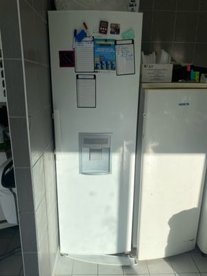 a white refrigerator with magnets on it in a kitchen