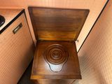 a wooden toilet with a wooden seat in a bathroom